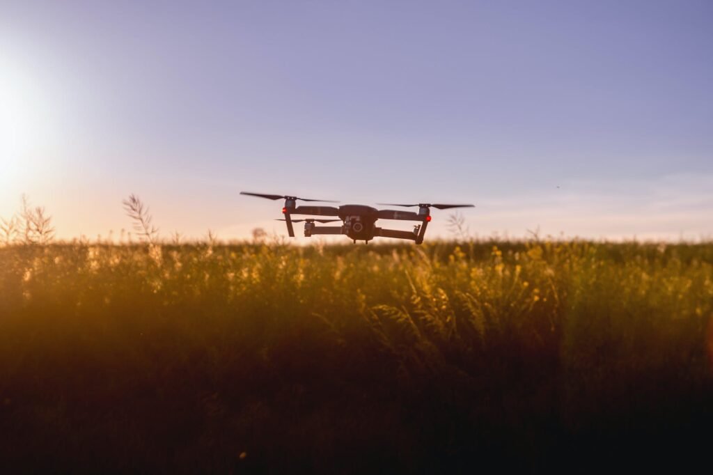 black quadcopter drone on green grass field