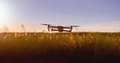 black quadcopter drone on green grass field