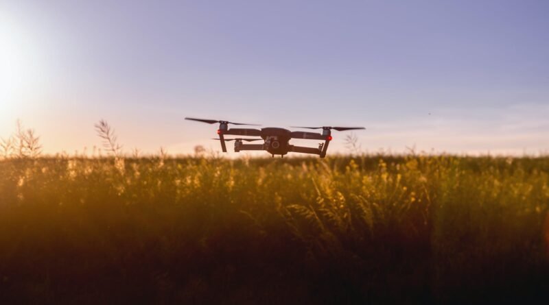 black quadcopter drone on green grass field