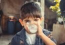 photo of boy drinking glass of milk