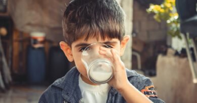 photo of boy drinking glass of milk